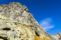 Climbers on a belay stance on the wall slabs while climbing on Mala Szarpana Turnia Maly Osarpanec, Tatra Mountains, Slovakia.