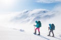 climbers climb the mountain. Winter mountaineering. two girls in snowshoes walk through the snow Royalty Free Stock Photo