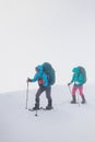 climbers climb the mountain. Winter mountaineering. two girls in snowshoes walk through the snow Royalty Free Stock Photo