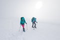 climbers climb the mountain. Winter mountaineering. two girls in snowshoes walk through the snow Royalty Free Stock Photo