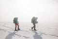 climbers climb the mountain. Winter mountaineering. two girls in snowshoes walk through the snow Royalty Free Stock Photo