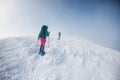 climbers climb the mountain. Winter mountaineering. two girls in snowshoes walk through the snow Royalty Free Stock Photo