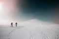 climbers climb the mountain. Winter mountaineering. two girls in snowshoes walk through the snow Royalty Free Stock Photo