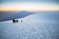 Climbers climbing Mount Ararat along the steep slope of the glacier in front of the summit