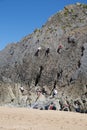 Climbers climbing rocks Three cliffs bay The Gower wales uk Royalty Free Stock Photo