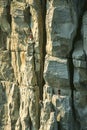 Climbers conquering challenging rock formations in mountain.