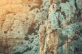 Climbers conquering challenging rock formations in mountain.