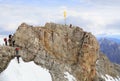 Climbers at the cross on the summit of Zugspitze Mountain, Germany.