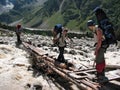 Climbers are crossing a mountain river. Caucasus, Russia.