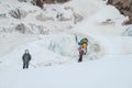 Climbers on glacier traver mountain route attached to the alpinist rope