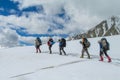 Climbers on glacier traver mountain route attached to the alpinist rope Royalty Free Stock Photo