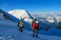 Climbers on glacier traver mountain route attached to the alpinist rope