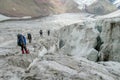 Climbers on glacier traver mountain route attached to the alpinist rope Royalty Free Stock Photo