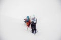 Climbers go in a snowstorm on the ascent