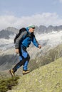 Climbers hiking in the Alps on a steep rock