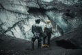 Climbers look at giant rocks and ice blocks