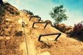 Climbers metal ladder via ferrata. Iron twisted rope fixed in block by screws snap hooks. The rope end anchored into sandstone roc Royalty Free Stock Photo