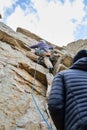 Climbers practicing rock climbing on a rock face.