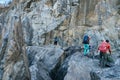 Climbers preparing for ascent. Three male female persons walking on the rocks Royalty Free Stock Photo