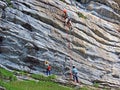 Climbers on rocky cliffs above Lake Melchsee in the Swiss Alps and in the Uri Alps massif, Melchtal - Switzerland Royalty Free Stock Photo