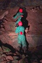 Climbers scaling a rock face inside a cave Royalty Free Stock Photo