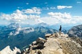 Climbers silhouette standing on a cliff in Dolomites. Tofana di Mezzo, Punta Anna, Italy. Man Celebrate success on top of the moun