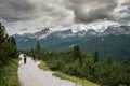 Climbers walking down a road in a Dolomite mountain landscape after a hard climb