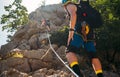 Climbers woman and man in protective helmets and climbing harnesses ascending cliffs on rock wall in Paklenica National park site Royalty Free Stock Photo