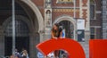 Climbing on the Amsterdam letters at National Museum - very popular by tourists - AMSTERDAM - THE NETHERLANDS - JULY 20