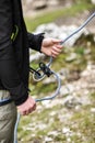 Climbing belayer holding rope in his hands