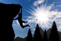 Climbing climber on top of mountain on background of mountain scenery Royalty Free Stock Photo