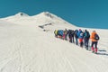Climbing Elbrus group of climbers goes in the snow to the top.