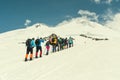 Climbing Elbrus group of climbers goes in the snow to the top.