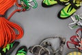 Climbing equipment laid out on on a black background. Rope, climbing shoes, chalk bag, quickdraws, belay, rappel device with carab