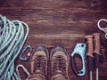 Climbing equipment: rope, red helmet, hammer, trekking shoes and other set  on dark wooden background, top view Royalty Free Stock Photo