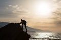 Climbing hiking silhouette in mountains and ocean