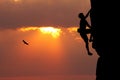 Climbing man at sunset