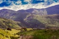 Climbing mount Snowdon in summer. Scattered clouds shadowing the landscape Royalty Free Stock Photo