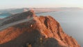 Climbing over the tops of the cliffs in the rays of the evening sun, a view from a height of the bay