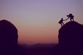 Climbing people in mountains as symbol for team spirit