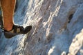 Climbing shoes on the climber`s foot rest the toe on the rock. Extreme sports, mountain tourism. Close-up. Copy space. Hairy male