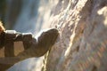 Climbing shoes on the climber`s foot rest the toe on the rock. Extreme sports, mountain tourism. Close-up. Copy space. Hairy male