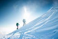 Climbers climb to the top of the mountain in winter Royalty Free Stock Photo