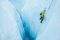 Climbing a steep route out of a large hole on a glacier ice climb