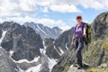 Climbing. Woman stands on edge of peak