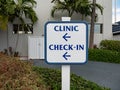 Clinic check-in inscription on sign post. Navigation sign. Wayfinding concept