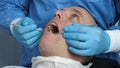 In the clinic hospital The doctor doctor`s assistant checks the patient`s teeth for the treatment of tartar and plaque, dental Royalty Free Stock Photo