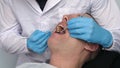 In the clinic hospital The doctor doctor`s assistant checks the patient`s teeth for the treatment of tartar and plaque, dental Royalty Free Stock Photo