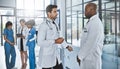 Clinical collaborations. two doctors having a discussion in a hospital.