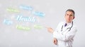 Clinical doctor pointing to health and fitness collection of words